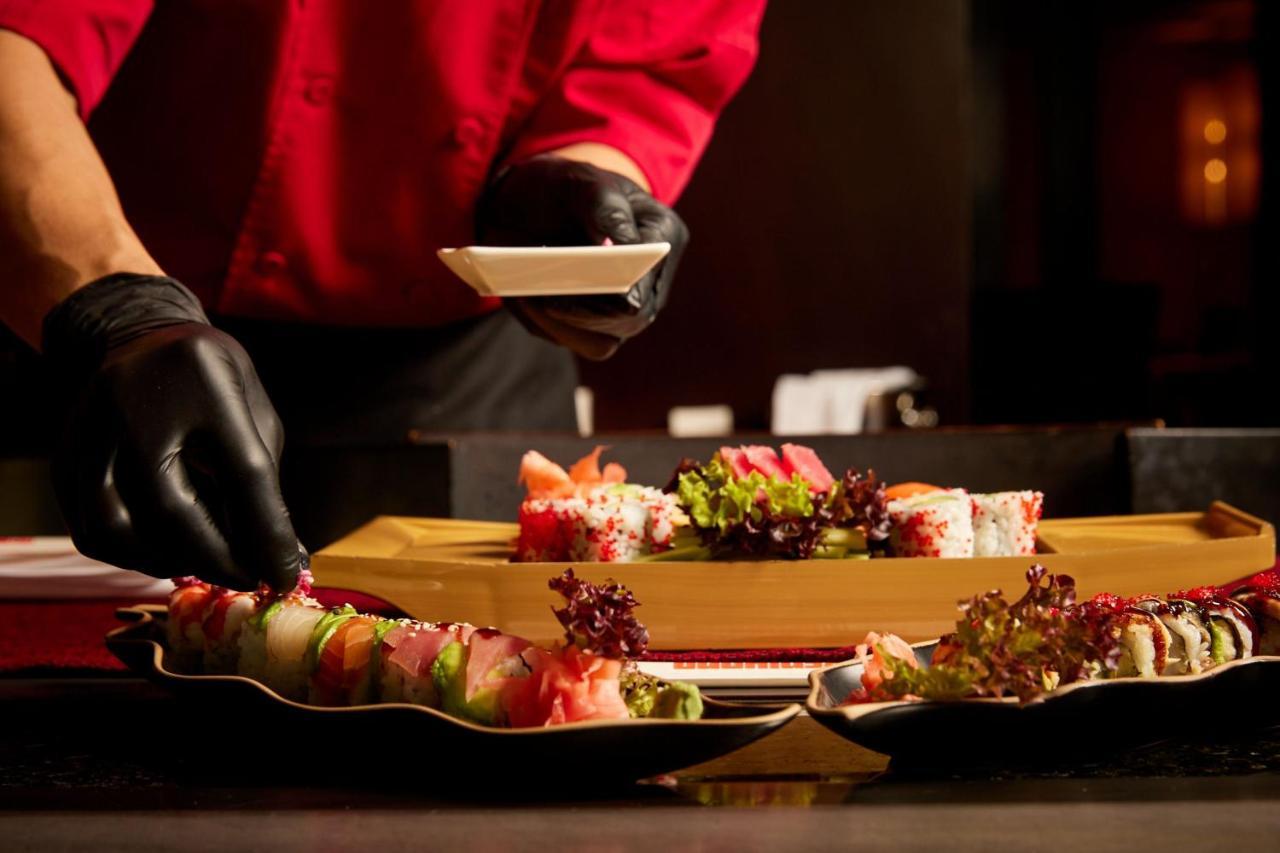 Sheraton Bucharest Hotel Kültér fotó A sushi chef preparing sushi